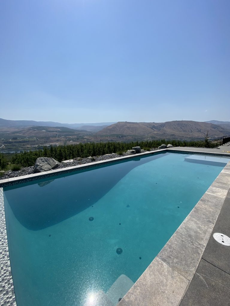 Infinity pool with mountain and lake view