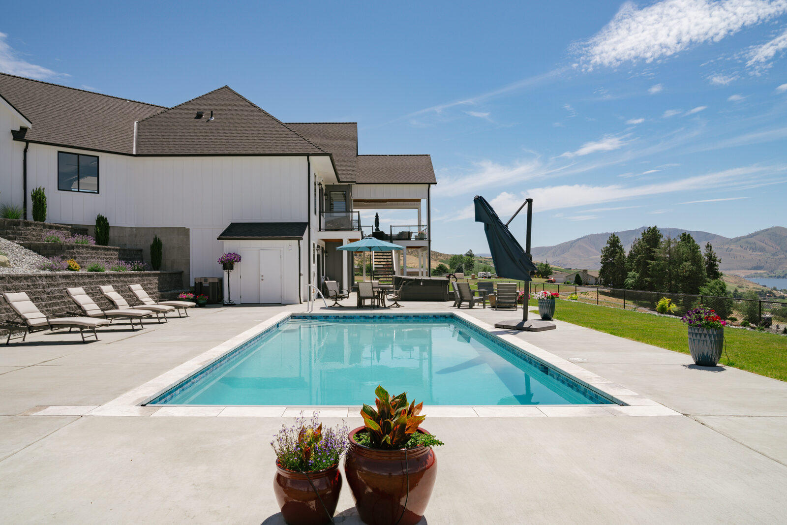 Custom pool with modern farmhouse and mountain vista