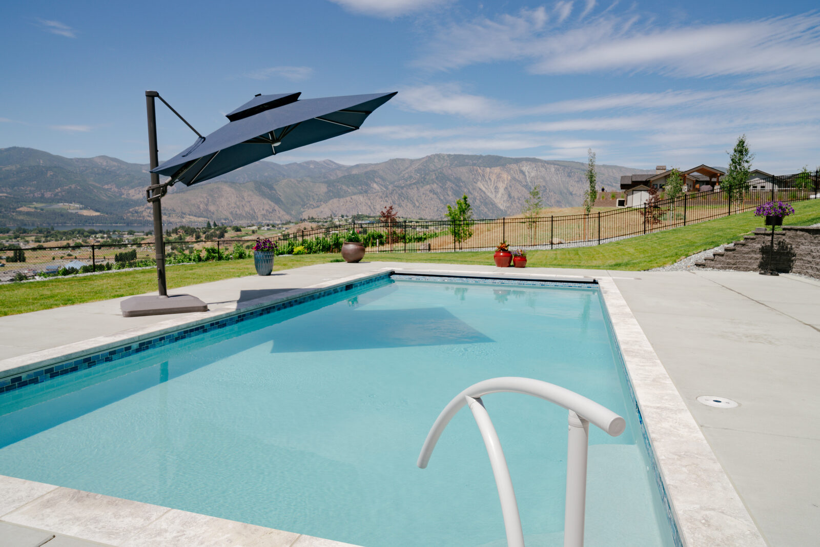 Hillside custom pool with cantilever umbrella